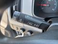 A close-up of the steering wheel controls in a 2017 Chevrolet Colorado showing buttons for menu navigation and light settings