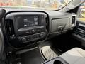 Interior view of a 2018 Chevrolet Silverado 1500 featuring a dashboard with a touchscreen display and climate control buttons