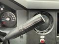 Close-up of the gear shift lever of a 2012 Ford F-450 SD showing textured black grip and dashboard controls