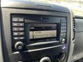 Dashboard display of a 2016 Mercedes-Benz Sprinter featuring radio controls and audio settings