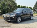 A 2013 BMW X3 in black with silver alloy wheels parked on a street showcasing its sporty design and distinct kidney grille