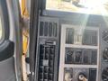 Close-up of a 1997 Freightliner FL70 dashboard featuring control switches for lights and windshield wipers along with air vents and ignition key slot