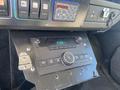 Dashboard of a 2011 Chevrolet Express showing a radio unit with a digital clock display and various controls
