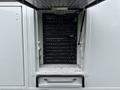A metal cabinet with a black control panel filled with switches and knobs, part of a 2011 Ford F-650 vehicle
