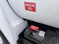 Close-up of a 2018 Ford F-750 fuel tank with a red "GASOLINE ONLY" label visible on the tank and another sticker providing fuel information