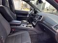 Interior view of a 2015 Jeep Grand Cherokee showcasing the front seats center console and dashboard with a focus on the modern design and controls