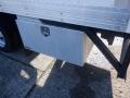 A metal storage box attached to the side of a 2015 Hino 195 truck displaying a secure locking mechanism