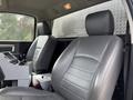 Interior of a 2016 RAM 5500 featuring two gray leather seats with manual controls on the center console between them