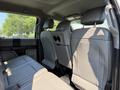 Interior view of a 2018 Ford F-550 showing the rear seating area with gray upholstery and headrests