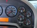 Dashboard of a 2010 International 4300 displaying speedometer fuel gauge voltmeter and air pressure gauges