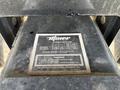 A close-up of a metal hitch plate with a warning label and detailed specifications for towing ratings and capacities