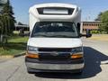 A 2017 Chevrolet Express van with a white exterior and a prominent front grille featuring the Chevrolet logo and large headlights