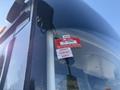 A close-up of a 2016 Grande West Vicinity bus windshield displaying a certificate of approval sticker with details for the months of January February and March