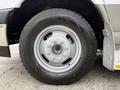 A silver wheel and tire from a 2020 Chevrolet Express with a six-bolt pattern and rugged tread design