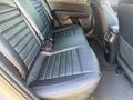 Interior view of the back seats of a 2024 Kia Forte5 featuring black leather upholstery with red stitching and a sleek design