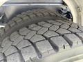 Close-up of the tread on two large truck tires showing deep grooves and a rugged surface designed for traction and stability on various terrains