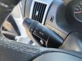 A black lever control on the steering column of a 2020 RAM ProMaster 3500 with symbols for headlights windshield wipers and turn signals