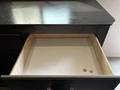 An open drawer of a 2021 Jayco Jay Flight with a plain interior and two coins resting on the bottom
