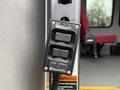 A BraunAbility control panel with two buttons labeled up and down mounted on a pole inside a vehicle