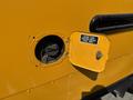 A yellow 2011 Freightliner B2 fuel door open revealing the filling neck for ultra low sulfur diesel fuel only