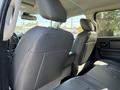 The image shows the rear interior of a 2019 RAM 1500 Classic featuring black leather seats and a center armrest with cup holders