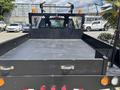 2017 Ford F-550 flatbed truck with a black bed and modified rear for utility purposes