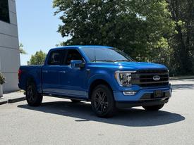 Blue 2021 Ford F-150 with a large cabin and sleek front design featuring a black grille and sporty wheels
