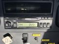A dashboard display of a 2005 Freightliner M2 106 showing a digital clock reading 344 PM with various control buttons and a parking brake lever