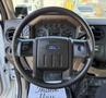 Steering wheel of a 2008 Ford F-550 with a Ford logo and control buttons on either side