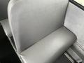 A gray seat interior from a 2007 Freightliner B2 bus with a simple design and smooth texture