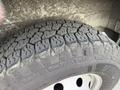 Close-up of a worn tire showing a rugged tread pattern on a RAM Promaster vehicle