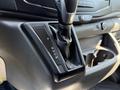 Close-up of the gear shift lever in a 2022 Ford Transit with options for park reverse neutral drive and manual