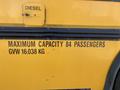 A 2006 Thomas Saf-T-Liner HDX school bus featuring text that indicates it is powered by diesel and has a maximum capacity of 84 passengers