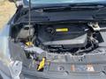 A 2015 Ford Escape engine compartment with various engine components visible including the engine block and fluid reservoirs