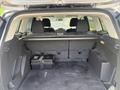 The interior of a 2015 Ford Escape showing the cargo area with a flat floor and storage compartments on either side