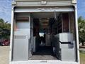 Image shows the interior of a 2011 Workhorse W62 truck with metal shelves cabinets and a clear view into the driver's area