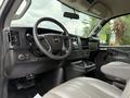 Interior of a 2021 Chevrolet Express showing the steering wheel dashboard controls and seating
