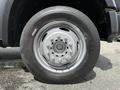 A close-up of a wheel from a 2008 Ford F-550 featuring a silver rim and black tire with visible tread patterns