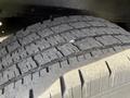 Close-up of a worn tire tread from a 2011 Ford Econoline showing detailed tread pattern and wear indicators