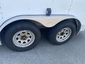 Two worn wheels on a 2008 Wells Industries Inc EW1422 trailer showing rust on the rims and treads