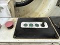 Control panel of a 2016 Peterbilt 348 featuring buttons and switches for pump engagement and adjustment