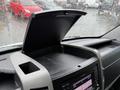 Dashboard of a 2017 Mercedes-Benz Sprinter with an open compartment above a digital display and controls