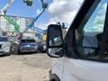 A white 2018 Ford Transit-350 van's side mirror is prominently displayed in the foreground
