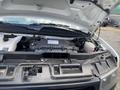 A 2023 GMC Savana with its hood open displaying the engine components and internal parts