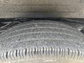 A close-up view of a worn tire on a 2021 Chevrolet Express showing visible tread wear and grooves