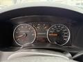 Dashboard of a 2012 GMC Canyon showing odometer reading 100095 km fuel gauge and speedometer with additional gauges for RPM and transmission gear