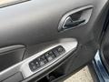 Interior door panel of a 2013 Dodge Journey featuring window control buttons and a metallic handle