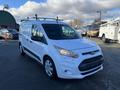 White 2017 Ford Transit Connect van with a roof rack parked at a lot