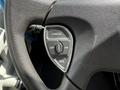 Close-up of a steering wheel control panel featuring buttons for cancel, set, on, and resume in a vehicle
