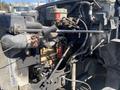A 1996 GMC Top Kick engine and mechanical components with visible hoses wiring and machinery detail